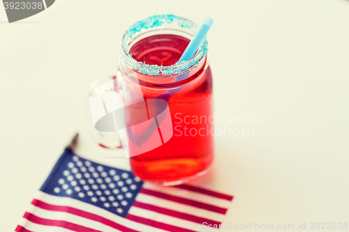 Image of juice glass and american flag on independence day