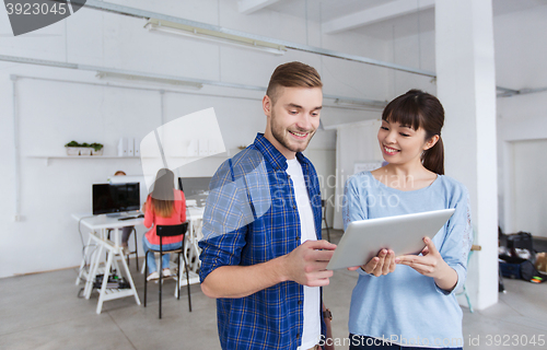 Image of couple with smartphone and tablet pc at office