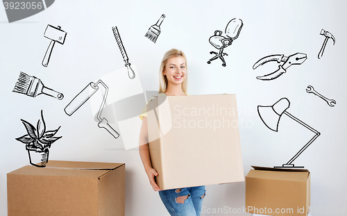 Image of smiling young woman with cardboard box at home