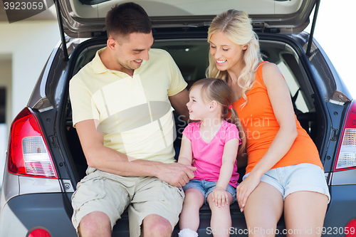 Image of happy family with hatchback car outdoors