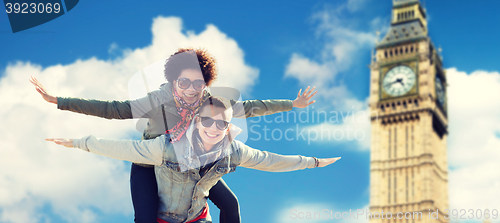 Image of happy teenage couple having fun over big ben tower