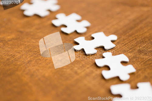 Image of close up of puzzle pieces on wooden surface