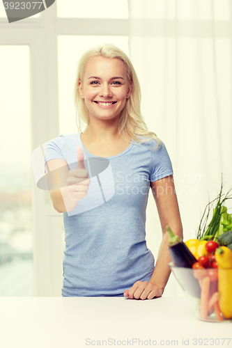 Image of happy woman with vegetables showing thumbs up
