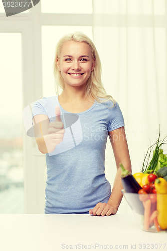 Image of happy woman with vegetables showing thumbs up