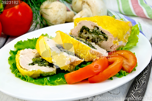 Image of Roll chicken with mushrooms on salad in plate