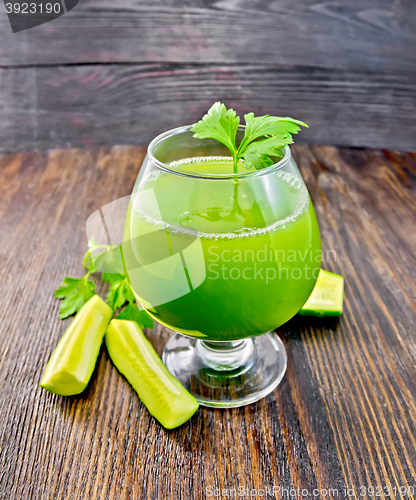 Image of Juice cucumber with parsley in wineglass on board