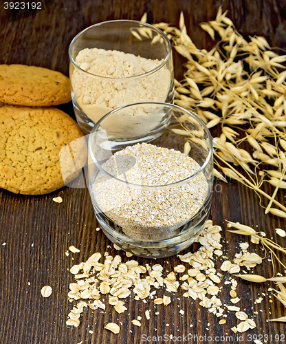Image of Bran and flour oat in glass with cookies on board