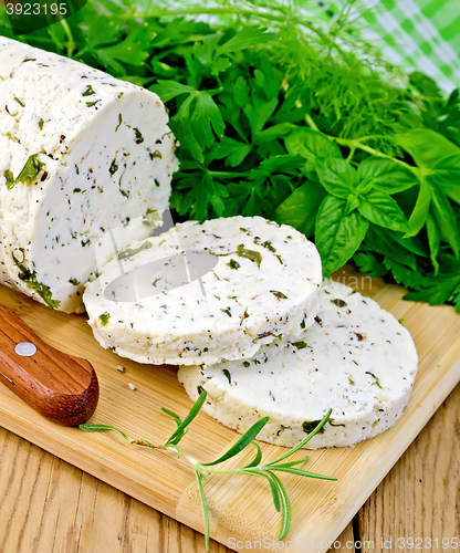 Image of Cheese homemade with spices and napkin on board