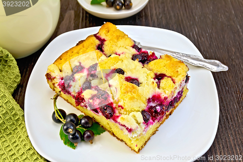 Image of Pie with black currant in plate and fork on board