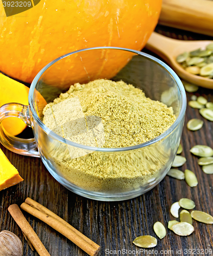 Image of Flour pumpkin in glass cup with cinnamon on board