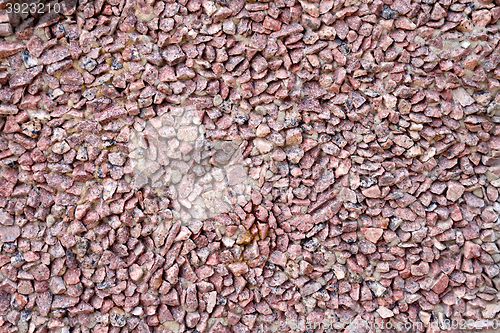 Image of Wall of red granite gravel