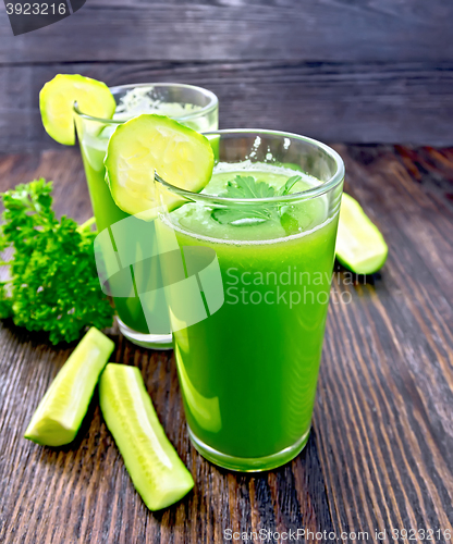 Image of Juice cucumber in two tall glass on dark board