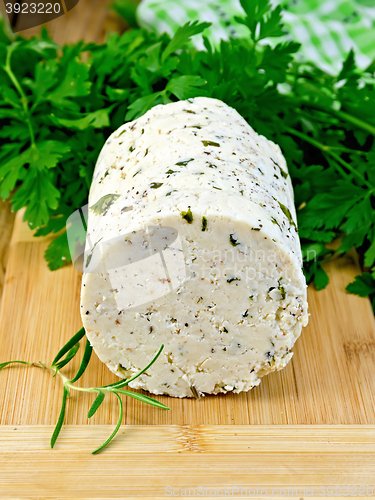 Image of Cheese homemade with spices and herbs on board