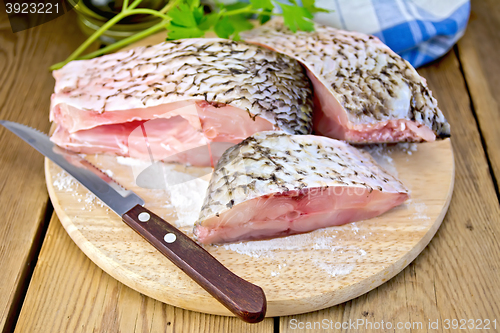 Image of Bream raw pieces on old board