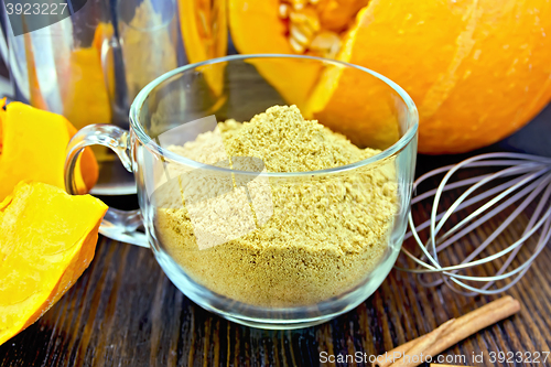 Image of Flour pumpkin in glass cup with sieve and a mixer on board