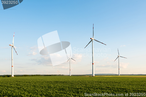 Image of Wind turbines in front of a coal-fired plant