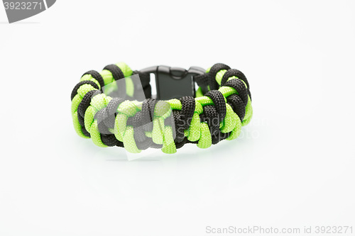 Image of green braided bracelet on white background