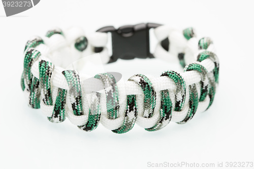 Image of green braided bracelet on white background