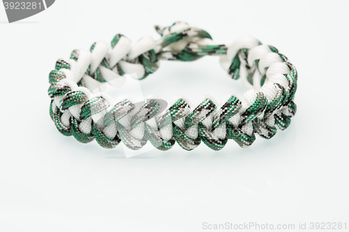 Image of green braided bracelet on white background