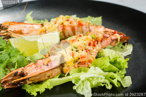 Image of perfect dish with shrimps on a black plate. seafood