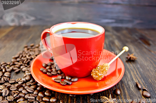 Image of Coffee in red cup with sugar on board