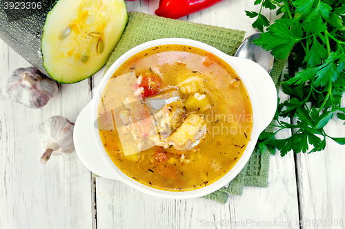 Image of Soup fish with zucchini and peppers on board top