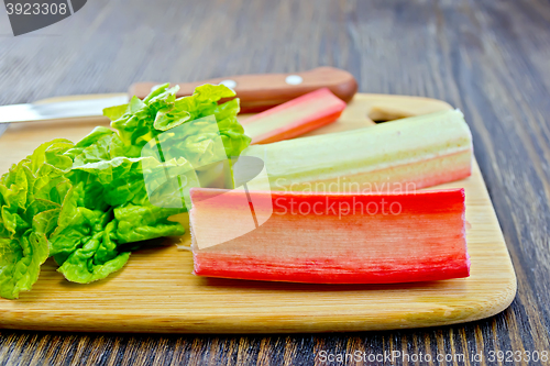 Image of Rhubarb with knife on dark board