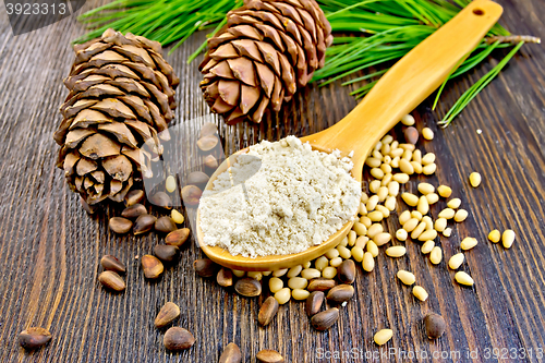 Image of Flour cedar in spoon and nuts on board