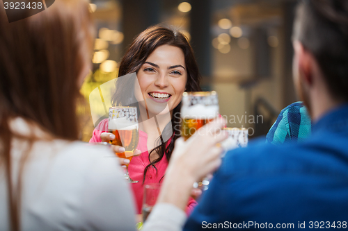 Image of friends dining and drinking beer at restaurant
