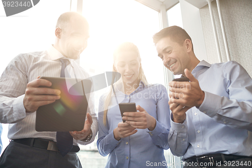 Image of business people with tablet pc and smartphones