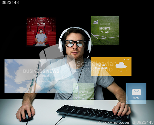 Image of man in headset computer over virtual media screens