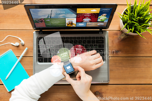 Image of close up of woman with smart watch and laptop