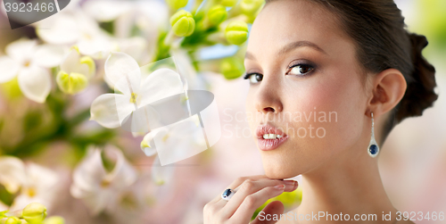 Image of beautiful woman with earring and finger ring