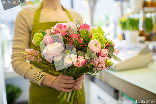 Image of close up of woman holding bunch at flower shop