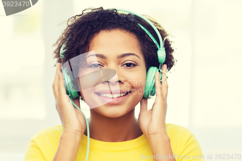 Image of happy woman with headphones listening to music