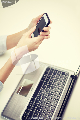 Image of close up of woman texting on smartphone at office