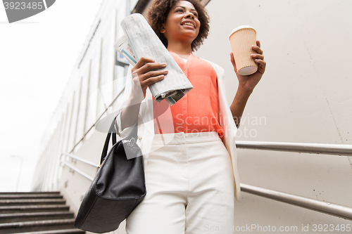 Image of close up of woman with coffee and newspaper