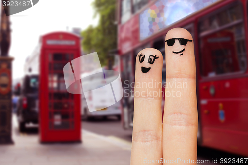 Image of close up of two fingers with smiley faces