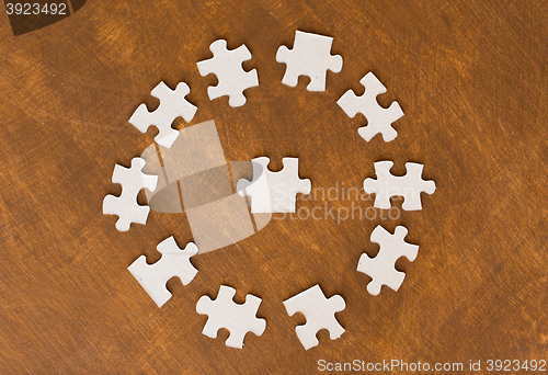 Image of close up of puzzle pieces on wooden surface