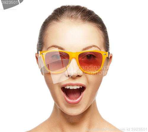 Image of happy amazed teenage girl in sunglasses