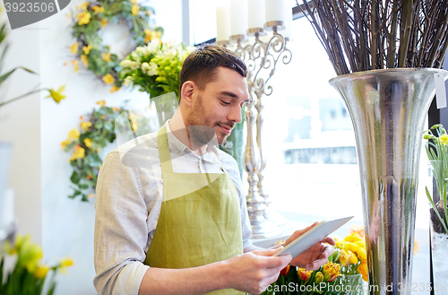 Image of man with tablet pc computer at flower shop
