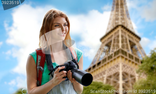 Image of woman with backpack and camera over eiffel tower