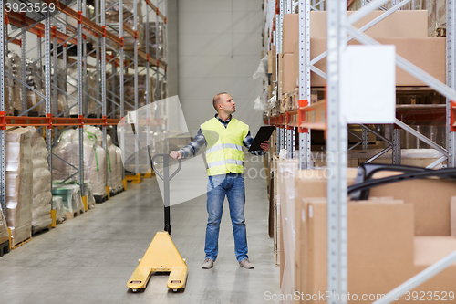 Image of man with loader and clipboard at warehouse