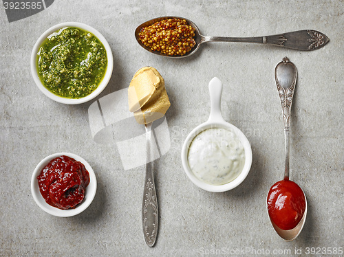 Image of various sauces in bowls and spoons