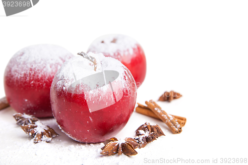 Image of Christmas apples and spices on white background