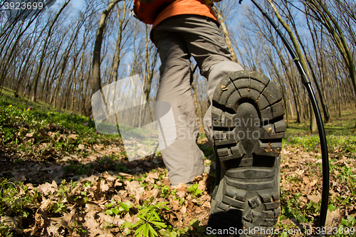 Image of Close up of hiker shoes boots and hiking sticks poles