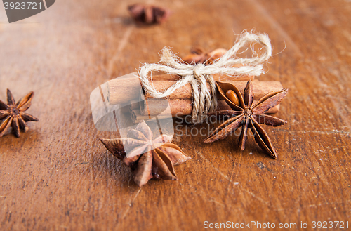 Image of Cinnamon sticks and star anise on rustic wood