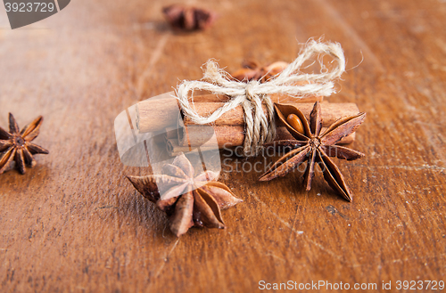 Image of Cinnamon sticks and star anise on rustic wood