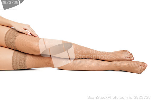 Image of Woman in stockings lying on floor