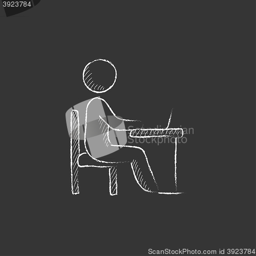 Image of Student sitting on chair in front of laptop. Drawn in chalk icon.